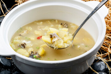 Potato and seafood soup in a white porcelain bowl