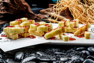 Delicious fried eggplant strips served on a white porcelain plate