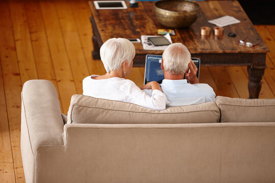 Home, back and old couple on sofa, laptop and financial audit with retirement funding. Pensioner, computer and woman on couch, man and email notification with budget report, internet and income