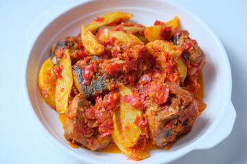 Indonesian homemade food tongkol balado. Fried tuna fish and potato with spicy red chili sambal