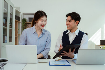 Obraz premium Asian young business people discussing on performance revenue in meeting. businessman working with co-worker team. financial adviser analysing data with investor.