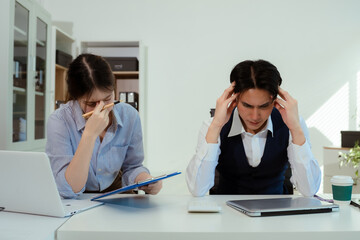 business people, teamwork, people and crisis concept - business team sitting sad and solving problems in the office.