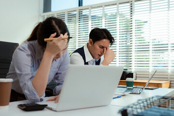 business people, teamwork, people and crisis concept - business team sitting sad and solving problems in the office.