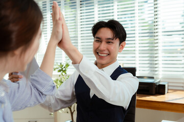 Happy creative business people are motivated, giving high five and celebration successful deal. Cooperation Meeting Partnership Career growth Team building Successful business.