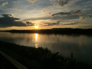 Riverside Landscape with Mountains during Sunset