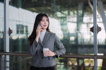 Fototapeta premium Businesswoman on phone call during business trip at airport