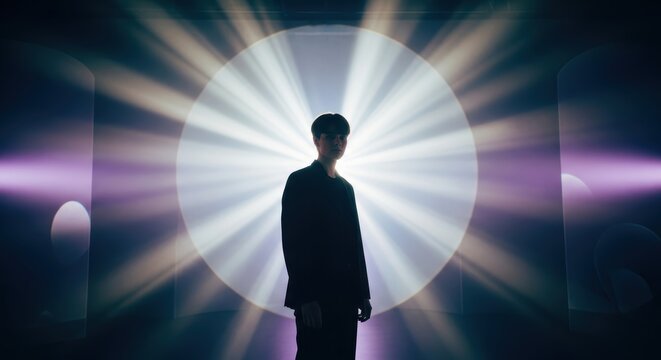 A mysterious individual silhouetted against a radiant burst of light, evoking intrigue and wonder