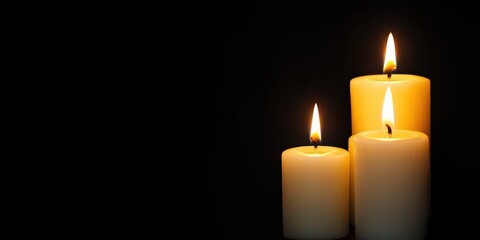 Three white candles burning brightly in the dark, symbolizing hope, remembrance, and peace, with ample copy space