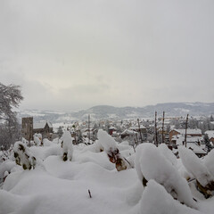 Village in Chartreuse Mountains covered in heavy first snowfall France