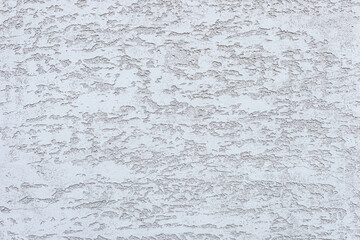 Textured white wall with subtle patterns and variations. The surface appears rough and uneven, creating an interesting visual effect.