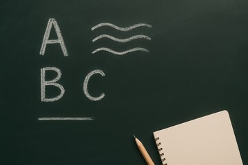 Chalkboard with Alphabet and Blank Notebook for Education or Learning