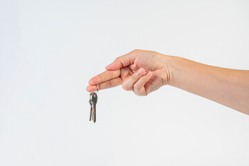 Key with a ring in hand on a white background.