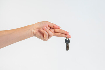 Key with a ring in hand on a white background.