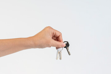 Key with a ring in hand on a white background.