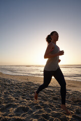 Fitness, sunset and woman running at beach for exercise, workout challenge and wellness at sea....