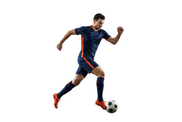 Male soccer player dribbling ball in mid stride on isolated black background, athletic action and competitive sports concept for training, fitness and team game promotion