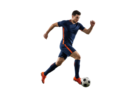 Male soccer player dribbling ball in mid stride on isolated black background, athletic action and competitive sports concept for training, fitness and team game promotion