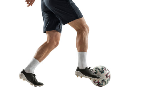 Male soccer player dribbling a ball in studio on white background, athletic legs in motion with cleats and socks for training, fitness and sports performance concepts