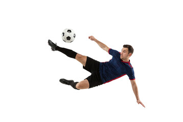 Fototapeta premium Male soccer player performing flying kick with focus on ball in mid air, action sports concept for competition training, athletic skill and dynamic movement isolated on transparent background
