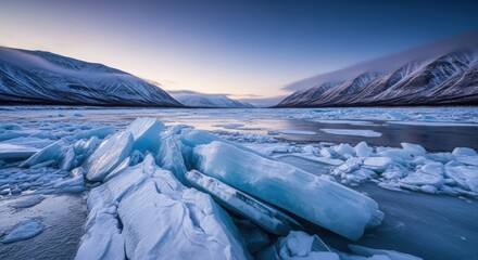 Winter landscape with frozen lake mountains and ice blocks during dusk