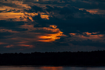 Beautiful sunset in the clouds over the river