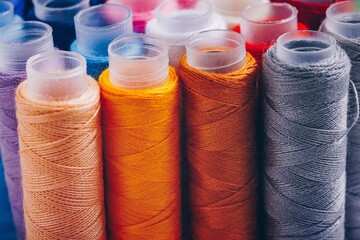 A Vibrant Collection of Sewing Threads in Various Colors Displayed in Neat Spools, Perfect for Crafting and Creative Projects, Enhancing Any Textile Work