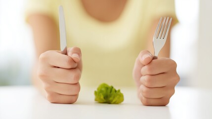 Eating vegetables. Healthy eating. Fork, knife and leaf of lettuce
