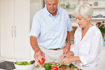 Old couple, cooking or chop vegetable in kitchen with healthy nutrition, meal preparation or bonding. Married, elderly people or cut ingredients in home with help for salad, food recipe or connection