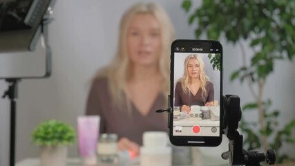 Girl beauty influencer or vlogger face with makeup spray or skincare advice, creating content for cosmetic promotion or online streaming. Woman holding product for tutorial, social media marketing