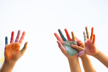 Bright painted children’s hands with smiling faces radiate joy, innocence, creativity, and playful unity — a vibrant celebration of childhood and togetherness.