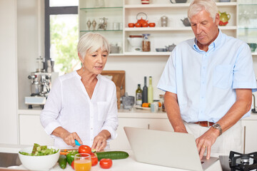 Old couple, chop vegetable or talk in kitchen with laptop for healthy diet, meal prep or cooking website. Married, elderly people or cut ingredients in home with computer, food recipe or instructions