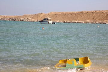 The Yellow Boat and the people having fun