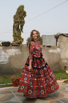 Beautiful young woman, tourist girl in traditional national Indian costume, Ahir dress. Village, India. Indian local people. Tribal native woman, Ahir tribe in Gujarat. Bride, bridal look. Beauty