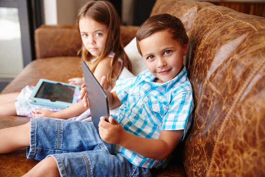 Education, portrait and tablet with children on sofa in living room of home for gaming. App, child development and learning with sibling kids in apartment for future, growth or video game streaming