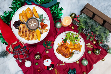 Festive Christmas feast served elegantly on a red tablecloth. The scene includes various dishes and seasonal decorations. 