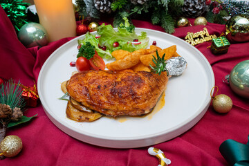 A festive and delicious holiday meal set on a table decorated with ornaments and a warm candle
