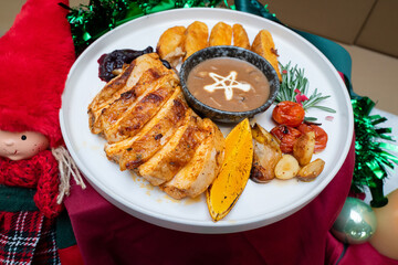 A delectable Christmas meal featuring roasted chicken, potatoes, and gravy, perfect for a festive feast.