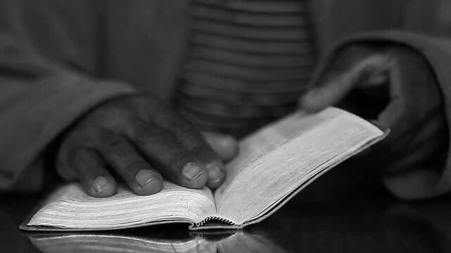 Christian praying man praying with hands together with holy bible on table on white background with people stock video stock footage