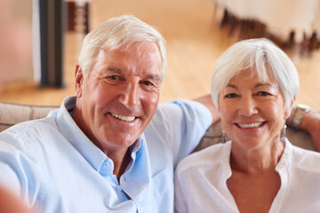 Selfie, happy and portrait of senior couple in home for memory, profile picture and bonding. retirement, marriage and pov of elderly man and woman on sofa for photo, social media and smile for love