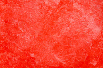 Abstract red textured background with subtle brush patterns and grunge effects. Bright red dominates the entire surface.