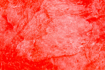 Abstract red textured background with subtle brush patterns and grunge effects. Bright red dominates the entire surface.