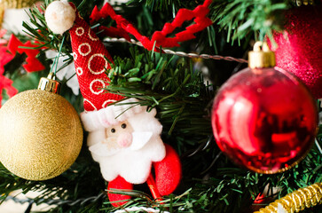 Festive Christmas Tree Detail with Santa Ornaments and Vibrant Colorful Baubles Sparkling in Holiday Cheer
