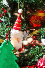 Festive Christmas Tree Detail with Santa Ornaments and Vibrant Colorful Baubles Sparkling in Holiday Cheer