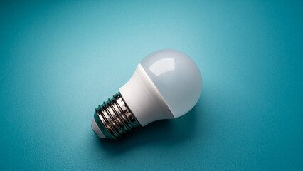 The modern LED bulb, with its bright white dome, is placed against a visually appealing, vibrant...