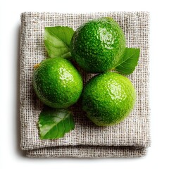 Fresh Green Limes with Leaves on Burlap Fabric, Top View on White