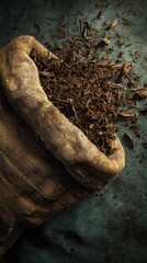 Artisanal Harvest - Loose Black Tea Spilling from a Rustic Burlap Sack in Dramatic Light.