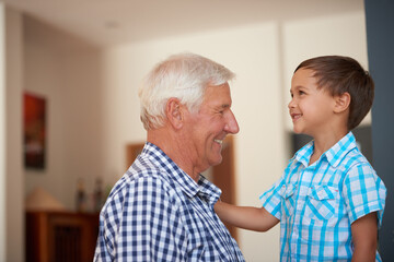 Smile, grandfather and talking with kid at house for love, affection and emotional support. Senior man, happy and listen to child for good behavior with reassurance, understanding and family bonding