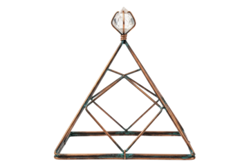 Copper wire meditation pyramid with quartz crystal point on isolated background
