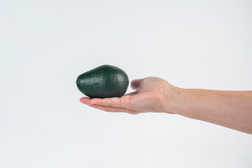 Avocado and hand isolated on white background close-up.