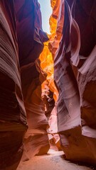 Narrow passage of sandstone canyons with sunlit opening
